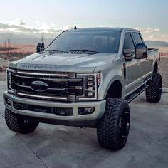 a silver truck parked on top of a parking lot