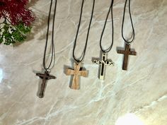 three wooden crosses hanging on a marble wall