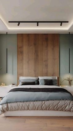 a large bed sitting in the middle of a bedroom next to a wooden headboard