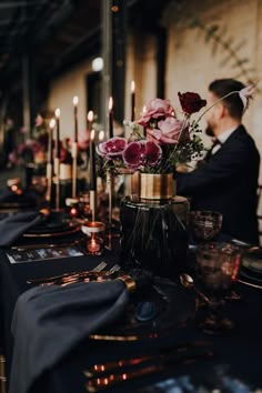 a long table with candles and flowers on it