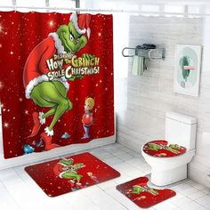 a bathroom decorated for christmas with the grin on it's shower curtain and rugs