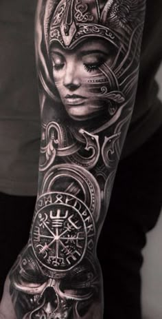 a man's arm with tattoos on it and an image of a woman in the middle