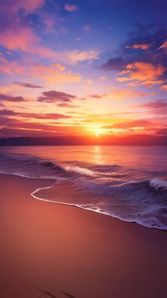 the sun is setting over the ocean with waves coming in to shore and footprints in the sand