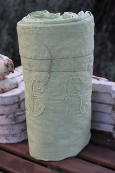 a roll of toilet paper sitting on top of a wooden bench