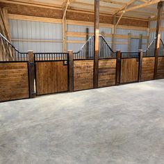 a man riding a skateboard on top of a cement floor next to wooden gates