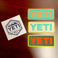 three stickers that say yeti, yeti and yeti on a table