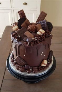 a large chocolate cake sitting on top of a wooden table