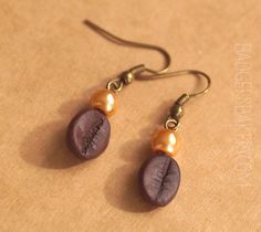 Please check my shop policies and FAQ before placing an order. Thank you :) Earrings for all coffee lovers. Realistic coffee beans handmade of polymer clay, adorned with pearly beads. Length (without the hook): 2cm (0,8'') Hook shape may vary depending on stock availability. The photo represents an item that is already sold - the pair you receive will be very similar but not identical. More coffee jewelry: Coffee cup pendant https://www.etsy.com/listing/129577593/coffee-cup-pendant-custom-toppin Faux Coffee, Bean Earrings, Earrings Coffee, Coffee Earrings, Coffee Jewelry, Tea Jewelry, Coffee Earring, Coffee Bean Earrings, Novelty Earrings