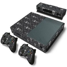 a video game console and controllers with skulls on the side, all in different designs