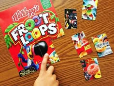 a person holding a mouse in front of a box of fruit loopss on a table