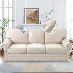 a living room with a white couch and rug