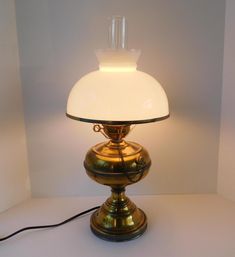 a lamp that is sitting on top of a table next to a white wall and floor