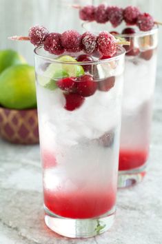 two glasses filled with ice and raspberries