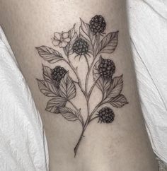 a black and white flower tattoo on the leg