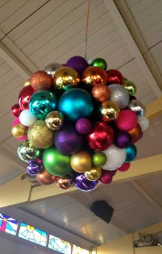 a bunch of christmas ornaments hanging from the ceiling