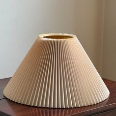 a lamp shade sitting on top of a wooden table