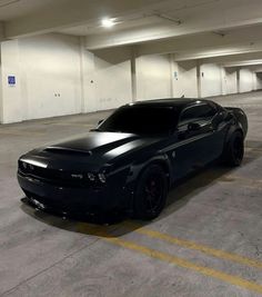 a black sports car parked in a parking garage