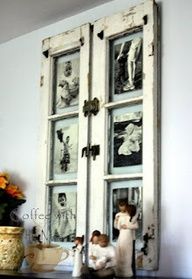 two children are standing in front of an old door with pictures on the glass and flowers