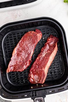 two steaks are being cooked in an air fryer