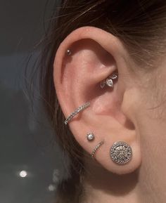 a close up of a person with ear piercings on their left and right sides