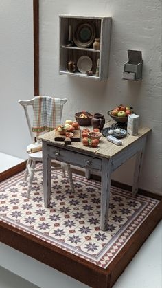 a miniature table and chair with food on it