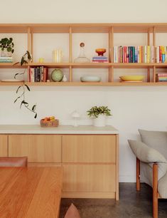 the shelves are filled with books and vases