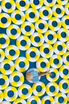 an overhead view of yellow and blue circles with a toy boat in the middle one