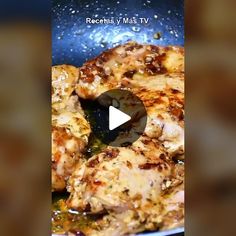 chicken is cooking in a frying pan with oil on it's side and the video appears to be blurry