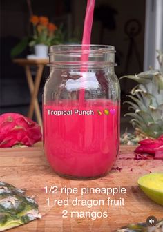 a pink smoothie in a jar with a straw