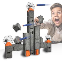 a boy is playing with blocks and magnets in front of a photo of him