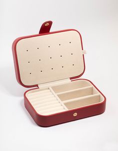 an open red and white suitcase on a white surface