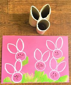 an easter craft made out of toilet paper and rolled up eggs with bunny faces on them