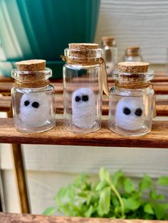 three glass jars with fake eyes in them