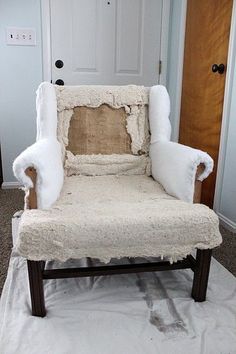 a chair that is covered in white fur