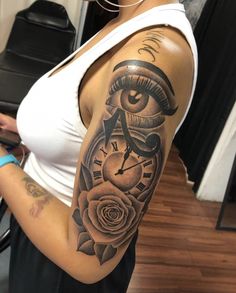 a woman with a clock and rose tattoo on her arm is looking at the camera