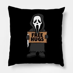 a black pillow with a cartoon character holding a sign that says free hugs on it