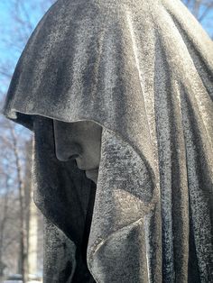 there is a statue with a hood on it