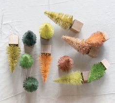 several different colored brushes are arranged on a white surface