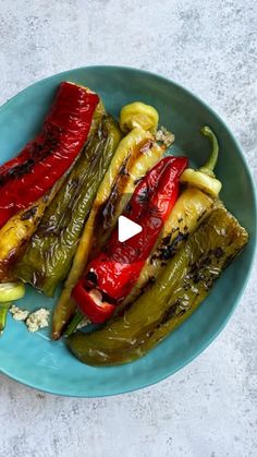 a blue plate topped with green and red peppers