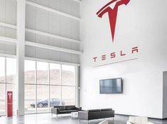 the interior of a tesla dealership with modern furniture