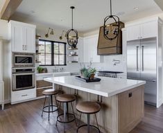 a kitchen with an island and two stools