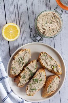 a white plate topped with bread covered in tuna pate