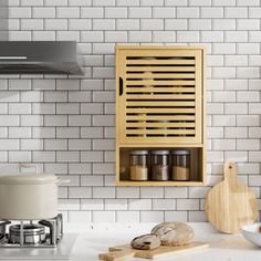 a wooden spice rack on the wall above a stove