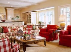 a living room filled with red and white furniture