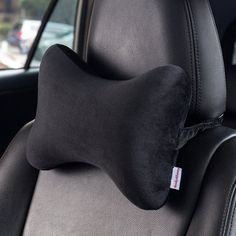 a car seat with a black pillow on it