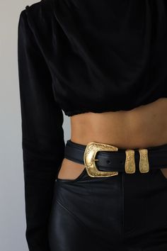 Add a vintage touch to your look with this western-inspired belt featured in black Italian leather, an eye-catching gold buckle, engraved details, and a metal tip. Feather Edge Adjustable Fit 1.5" Genuine Italian Leather Ethically Made in California Gold Western Belt, Black Belt With Gold Buckle, Chic Black Belt Buckles With Brass Detail, Chic Black Belt Buckles With Brass Buckle, Western Gold Belt With Antique Buckle, Elegant Gold Belt For Fall, Chic Black Belt With Brass Buckle, Gold Leather Belt For Fall, Chic Formal Antique Belt Buckle