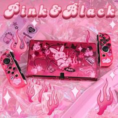 pink and black nintendo wii game console sitting on top of plastic wrapper with stickers all over it