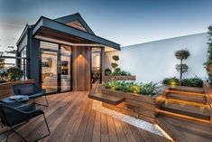 an outdoor deck with wooden steps and planters