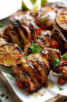 grilled chicken with pineapple slices and peppers on a cutting board