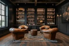 a living room with two leather chairs and a coffee table in front of the bar